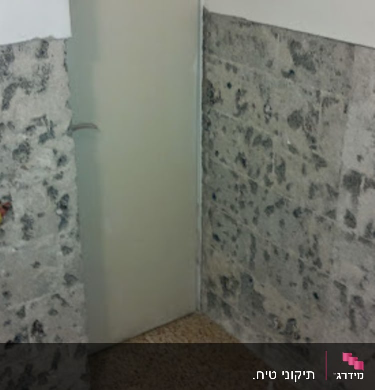 קיר בטון חשוף עם אריחים חלקיים בשיפוץ